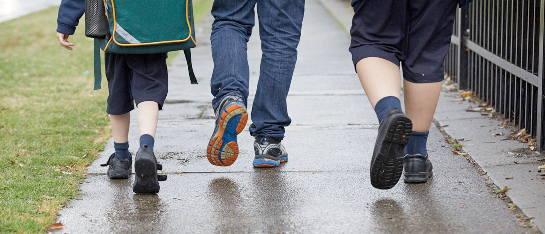 children walking to school with adult